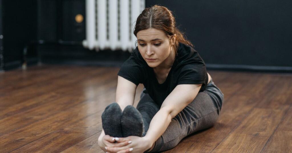 A women doing Seated Hamstring Stretches