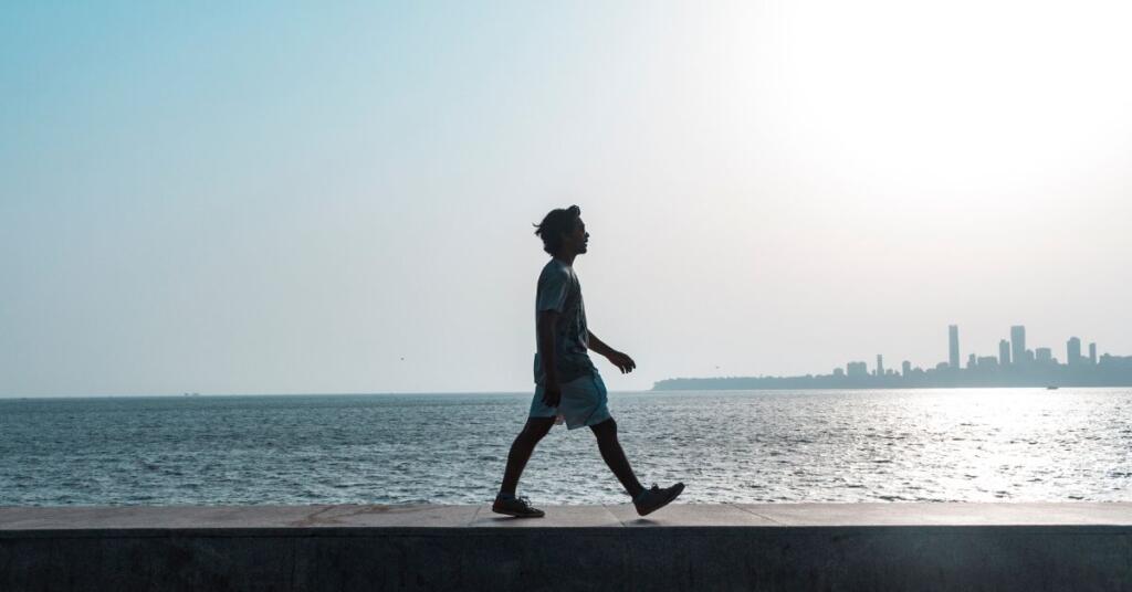 A man walking behing the sea