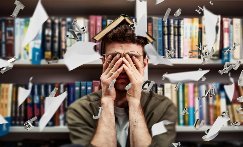 A student in stress sitting on chair in library