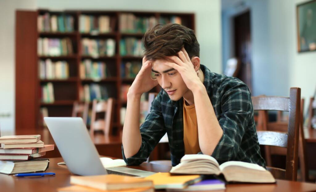 A student in stress sitting on chair in room